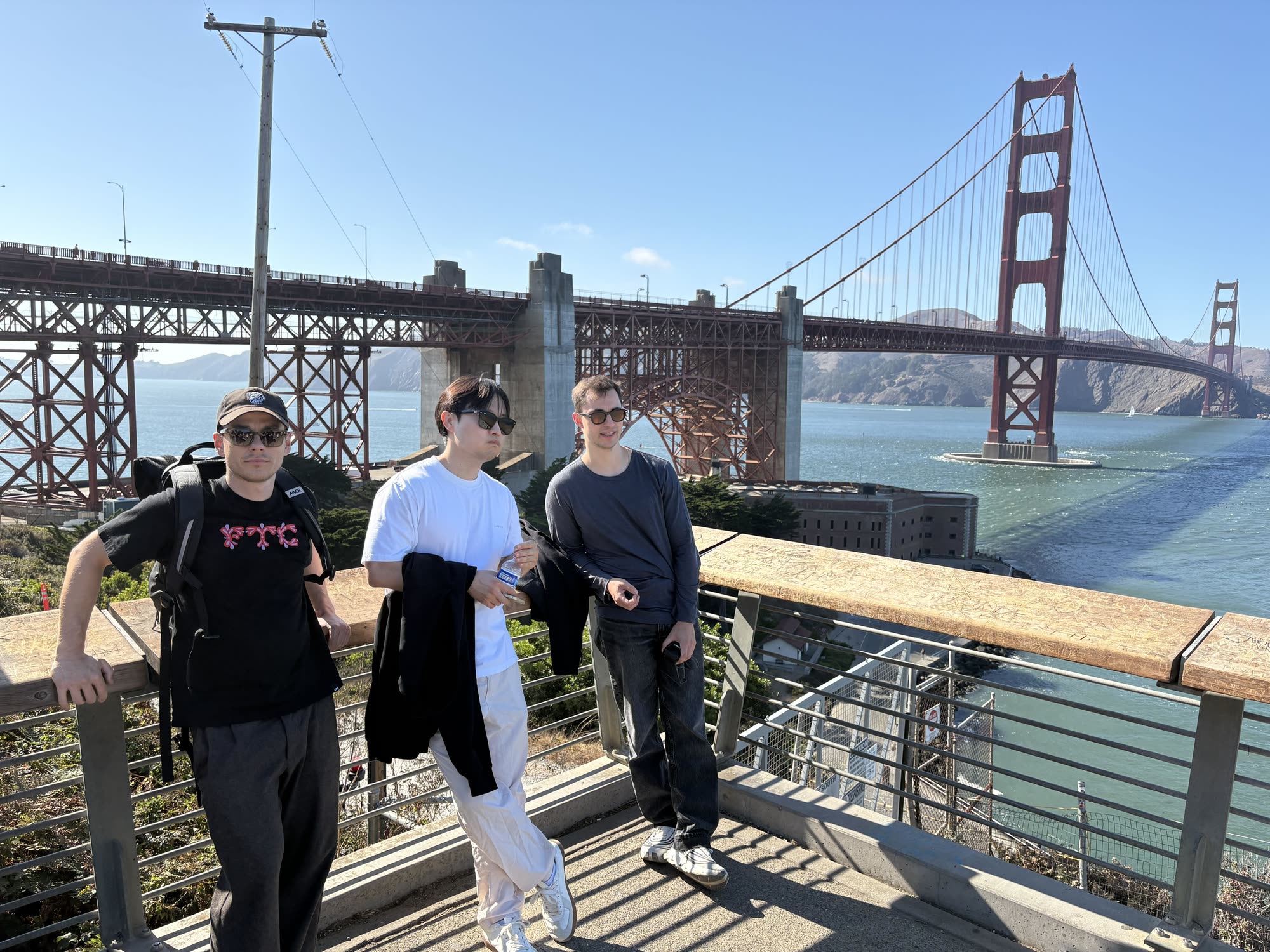 Three of the team at a railing with the Golden Gate Bridge behind them